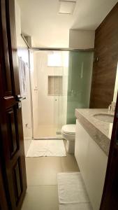 a bathroom with a shower with a toilet and a sink at Dom Carlos in Belém +15 photos