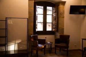 a room with two chairs and a table and a window at Palacio Soran in Leintz-Gatzaga