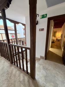 a room with a balcony with a staircase with a sign on the wall at RETIRO DEL TEATRO Hotel Boutique y Apartamentos en Almagro in Almagro