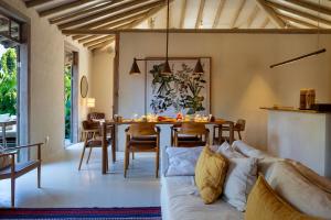 a living room with a couch and a table at Na Praça Hotel in Trancoso +76 photos