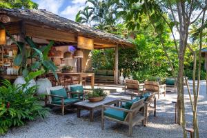 a patio with chairs and a table and a building at Na Praça Hotel in Trancoso