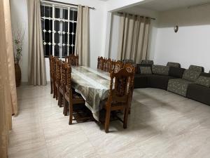 a living room with a table and chairs and a couch at Coastal Retreat Penthouse in Pereybere