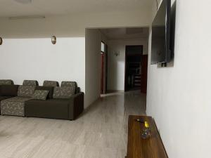 a living room with a couch and a table at Coastal Retreat Penthouse in Pereybere