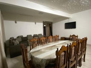 a conference room with a table and chairs and a couch at Coastal Retreat Penthouse in Pereybere +4 photos
