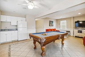a living room with a pool table in it at Hidden Treasure - Nags Head MP 16, Oceanfront, Private Beach Access, Pool, Hot Tub, Pool Table, Pets OK in Nags Head