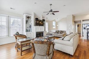 a living room with a couch and a fireplace at Hidden Treasure - Nags Head MP 16, Oceanfront, Private Beach Access, Pool, Hot Tub, Pool Table, Pets OK in Nags Head