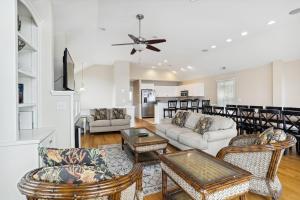 a living room with a couch and chairs at Hidden Treasure - Nags Head MP 16, Oceanfront, Private Beach Access, Pool, Hot Tub, Pool Table, Pets OK in Nags Head