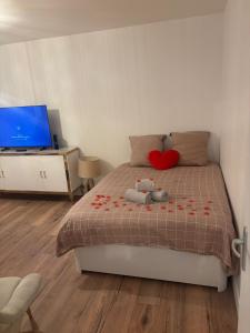 a bedroom with a bed with a stuffed animal on it at Le Cocon - Paris - Netflix - Parking in Noisy-le-Grand