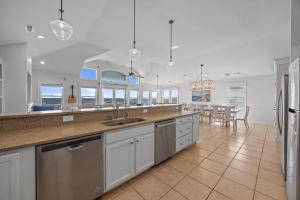 a kitchen with a sink and a counter top at Atlantic Watch in Kill Devil Hills