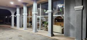 a building with columns and furniture in a room at Rodeway Inn Roswell in Roswell