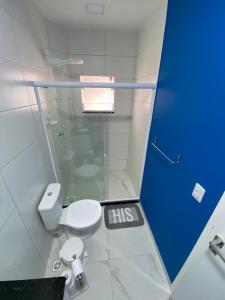 a bathroom with a toilet and a glass shower at Condomínio Aparte Hotel Laguna in Arraial do Cabo +29 photos