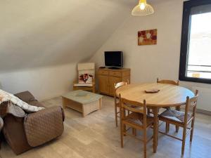 a living room with a table and a couch at La Fage in Nasbinals