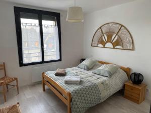 a bedroom with a bed and two windows at La Fage in Nasbinals