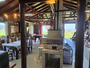 a kitchen with a brick oven in the middle of a room at Cabana da lagoa in Osório