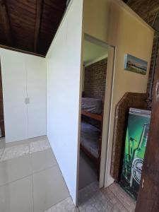 a room with a tv and a bed in a room at Cabana da lagoa in Osório +3 photos