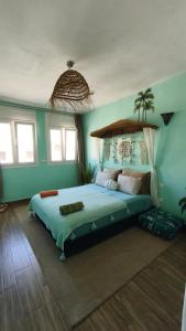 a bedroom with a large bed in a room at Premium Flat Agadir - Immersive rental --- Maison Bleue --- Fast wifi in Agadir