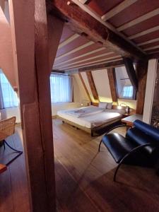 a bedroom with a bed in the middle of a room at Schiefes Haus in Ulm