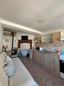 a large kitchen with a couch in a room at Happy Home LP in Gruda