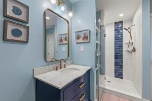 a bathroom with a sink and a shower at The Pickled Mermaid in Rodanthe +23 photos