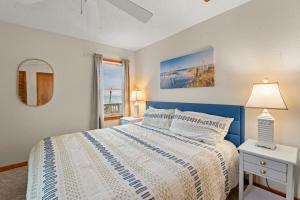 a bedroom with a white bed and a window at The Pickled Mermaid in Rodanthe