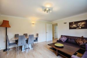 a living room with a couch and a table at Spacious 2-Bed Family Flat in Wimbledon Near Tube in London
