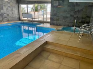 a large swimming pool with a clear blue water at Newydd nook in Anglesey