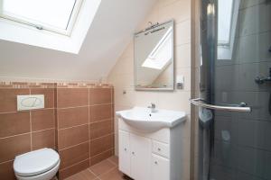 a bathroom with a sink and a toilet and a mirror at Willa Di Mare in Karwia +39 photos