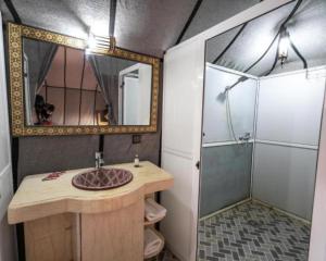 a bathroom with a sink and a shower at Luxury Desert Central Camp in Merzouga +22 photos