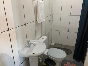 a small bathroom with a toilet and a sink at Pousada HG-102-Suíte in Vila Nova do Sul