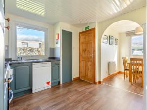 a kitchen with a sink and a counter top at Walled Cottage - Uk49097 in Inchnadamph +14 photos