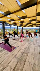 a group of people doing yoga on the beach at ChangoMango in La Ventana