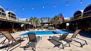 a group of chairs sitting next to a swimming pool at ChangoMango in La Ventana