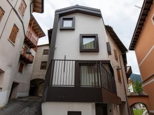 a white building with a balcony on a street at SKY LOVE Luxury Chalet in Andalo
