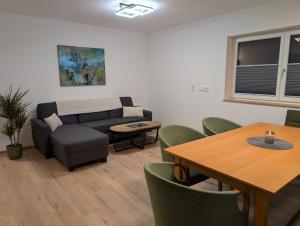 a living room with a couch and a table at Apartment Auszeit am See in Uttendorf +5 photos