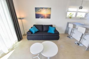 a living room with a couch and a table at Pool Apartments & Rooms Mare in Novalja