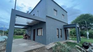 a blue house with a large garage at Blend- Casa descanso Cafayate in Cafayate