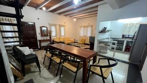 a living room with a wooden table and chairs at Blend- Casa descanso Cafayate in Cafayate