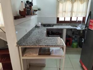 a small kitchen with a counter and a counter top at Blend- Casa descanso Cafayate in Cafayate