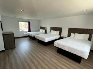 a hotel room with two beds and a window at Hyland Inn Van Nuys in Van Nuys