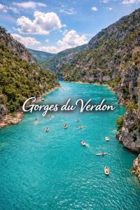 a river in a canyon with boats in the water at La Petite Escale Manosquine in Manosque
