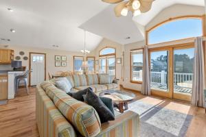 a living room with a couch and a table at Anchors Away in Corolla
