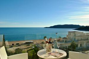 a table with wine glasses and a view of the ocean at Shine residence in Budva