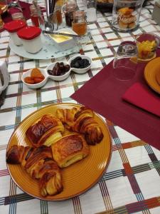 a plate of pastries and croissants on a table at L'Instant des Hôtes in Combrit