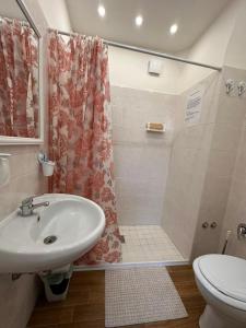 a bathroom with a sink and a shower and a toilet at Dea in Maddaloni