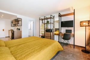 a bedroom with a yellow bed and a desk at Cosmo Napa Boutique Hotel in Ayia Napa