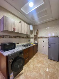 a kitchen with a stove and a dishwasher at maison de bonheur 2 in Tafraout