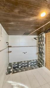 a room with a shower with a stone wall at Oasis Resort in Skardu +58 photos