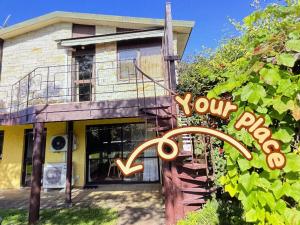 a house with a sign that reads your house at Guests suite close to Redwoods in Rotorua