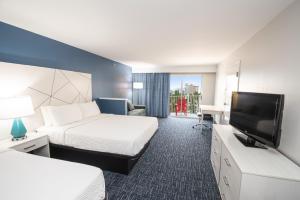 a hotel room with two beds and a flat screen tv at Bonita Beach Hotel in Ocean City