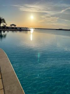 a view of a large body of water with the sun setting at Sunset Bliss in Abbeyville